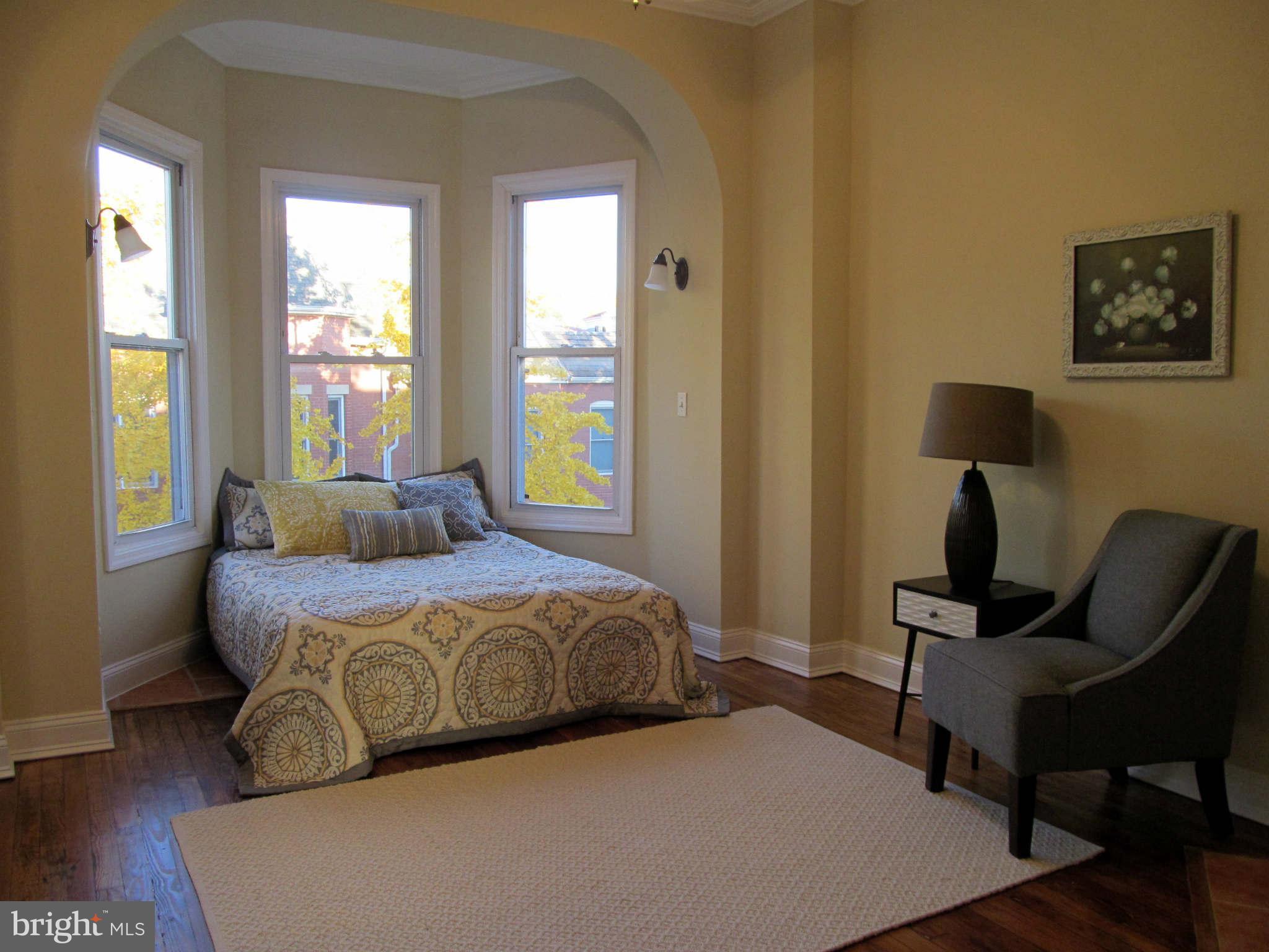 1908 6th Street Northwest Washington, DC 20001 - Photo 23 of 30 a spacious bedroom with a bed and wooden floor