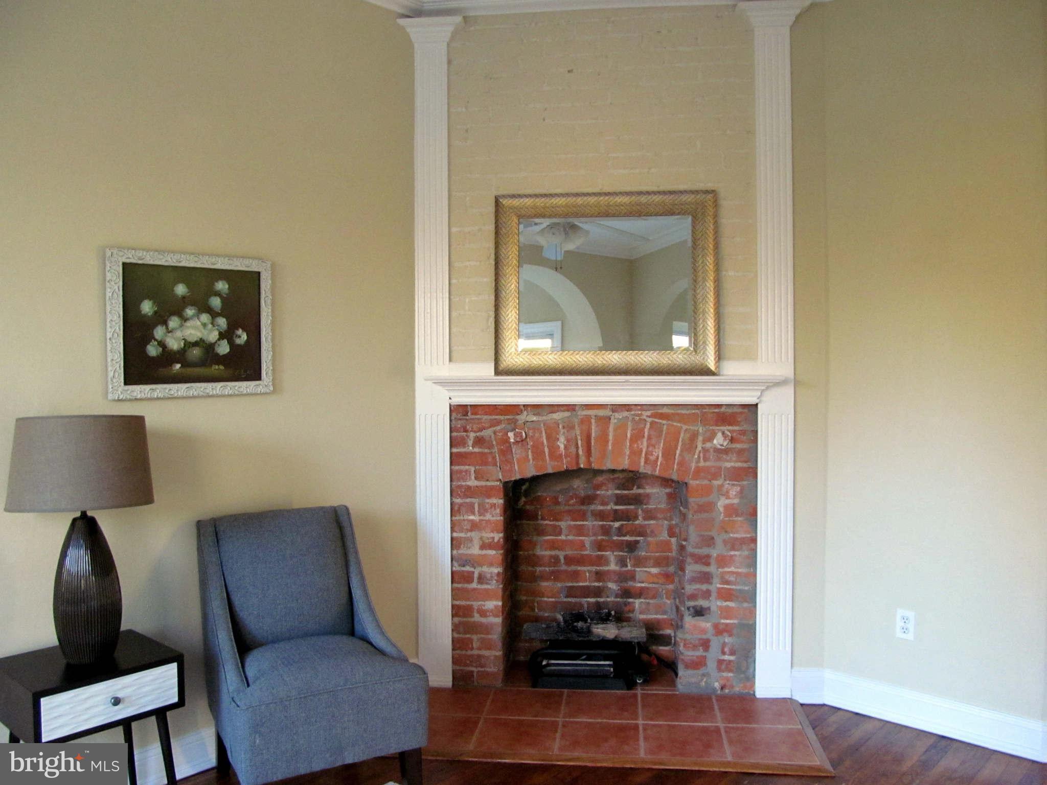 1908 6th Street Northwest Washington, DC 20001 - Photo 25 of 30 a living room with furniture and a fireplace