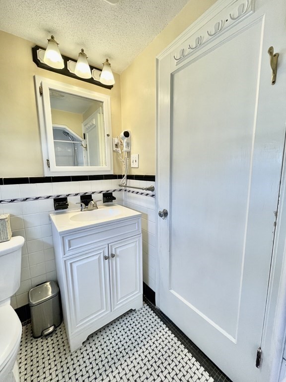 89 Wexford Street Springfield, MA 01118 - Photo 18 of 38 a bathroom with a sink a toilet a mirror and shower