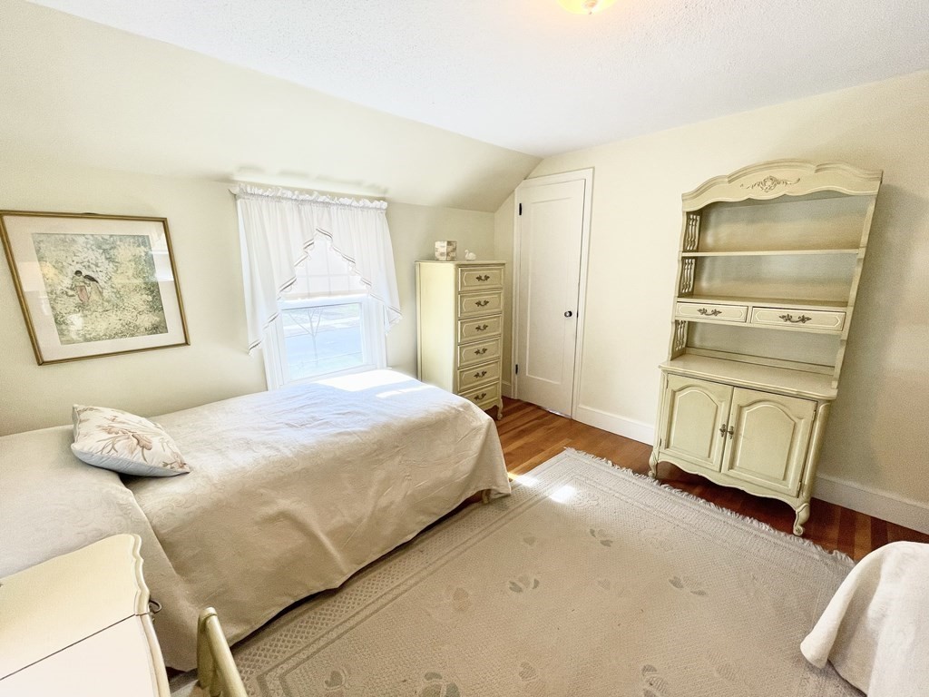 89 Wexford Street Springfield, MA 01118 - Photo 22 of 38 a bedroom with a bed and wooden floor