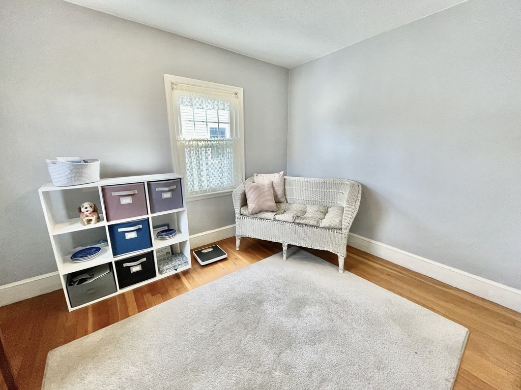 89 Wexford Street Springfield, MA 01118 - Photo 25 of 38 a living room with a bed and a wooden floor