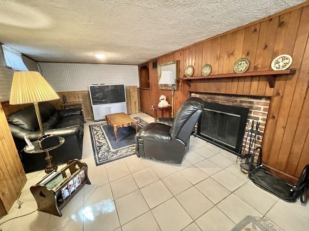 89 Wexford Street Springfield, MA 01118 - Photo 27 of 38 a living room with furniture a flat screen tv and a fireplace