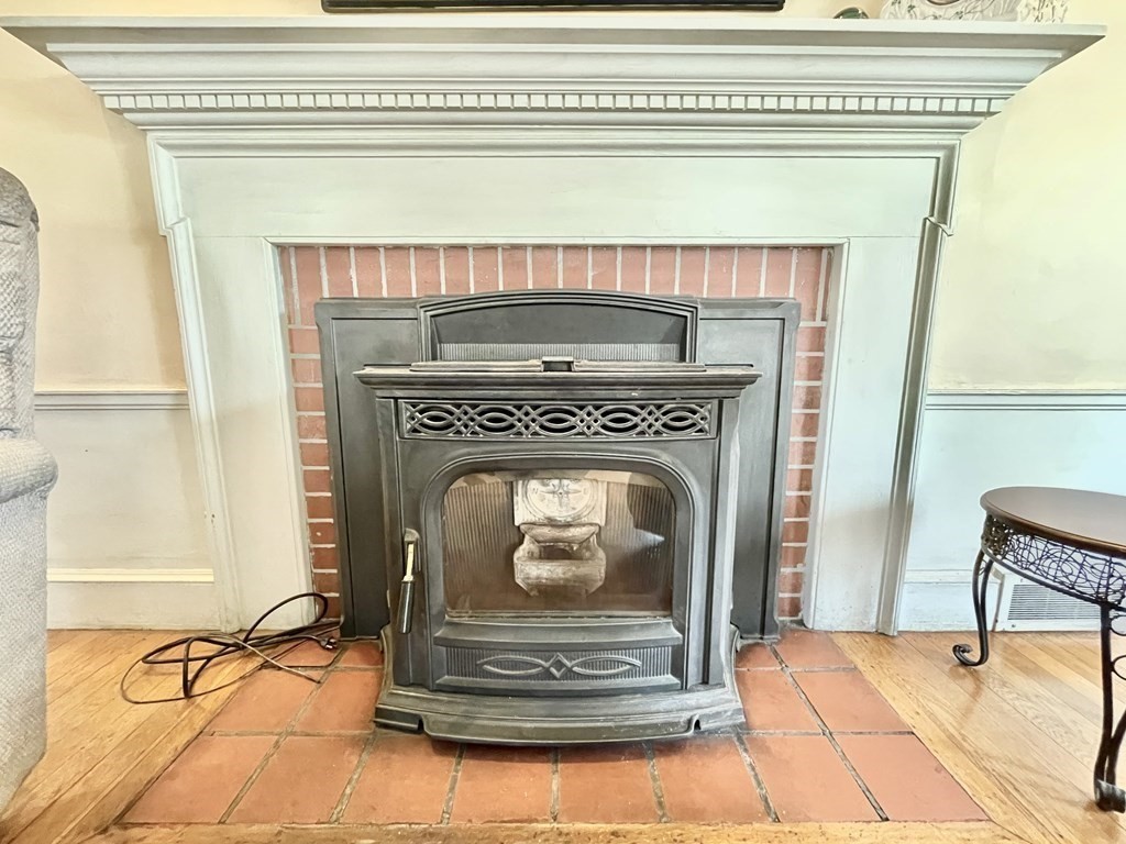 89 Wexford Street Springfield, MA 01118 - Photo 6 of 38 a fireplace with a fireplace in front of it