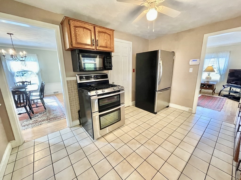89 Wexford Street Springfield, MA 01118 - Photo 10 of 38 a kitchen with stainless steel appliances kitchen island granite countertop a refrigerator and a sink