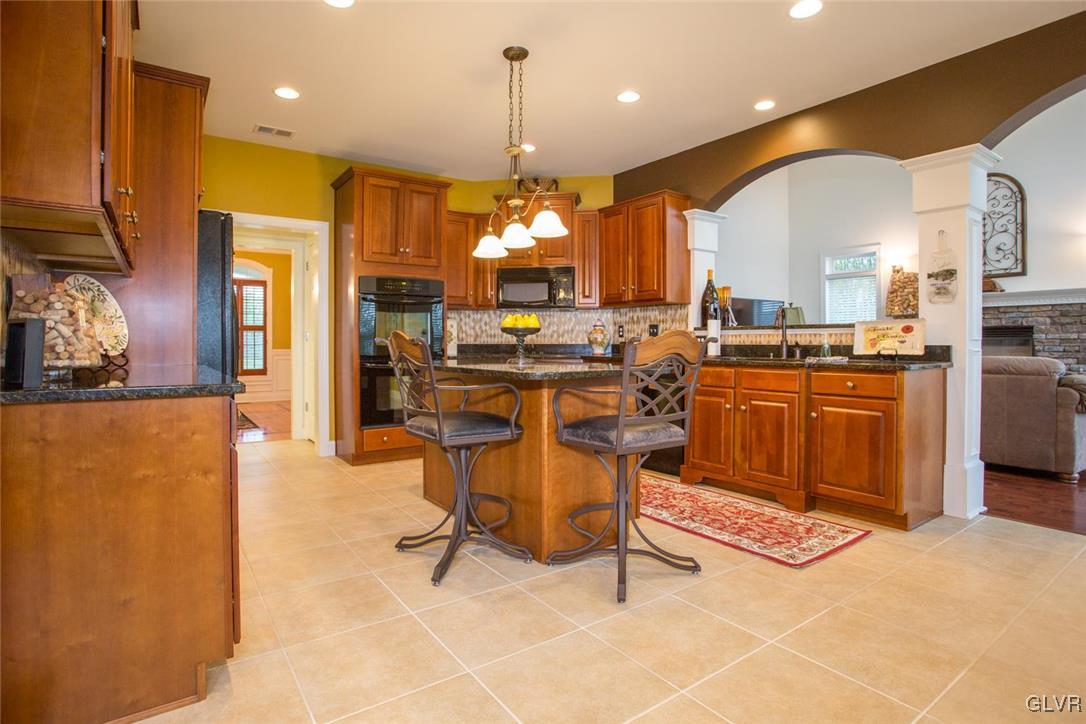 216 East Dell Road Bath, PA 18014 - Photo 15 of 42 a view of a kitchen with kitchen island granite countertop cabinets and a view of living room