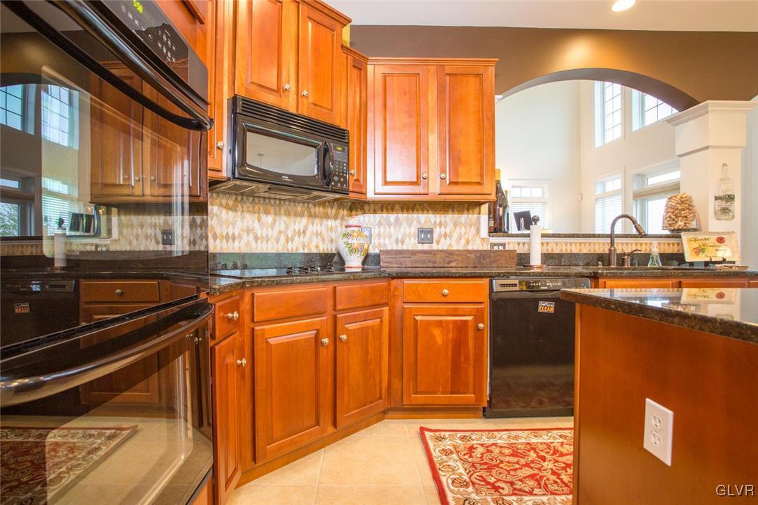 216 East Dell Road Bath, PA 18014 - Photo 16 of 42 a kitchen with stainless steel appliances granite countertop a stove a sink and a microwave