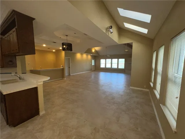 a spacious bathroom with a sink a large mirror and shower