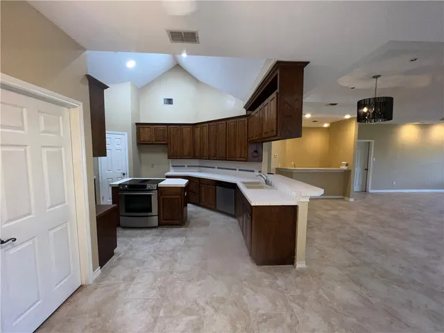 a kitchen with a sink and a stove top oven