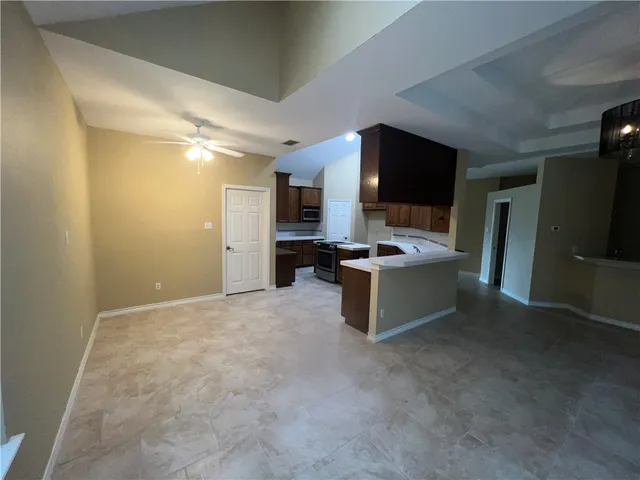 a large kitchen with a stove and a refrigerator
