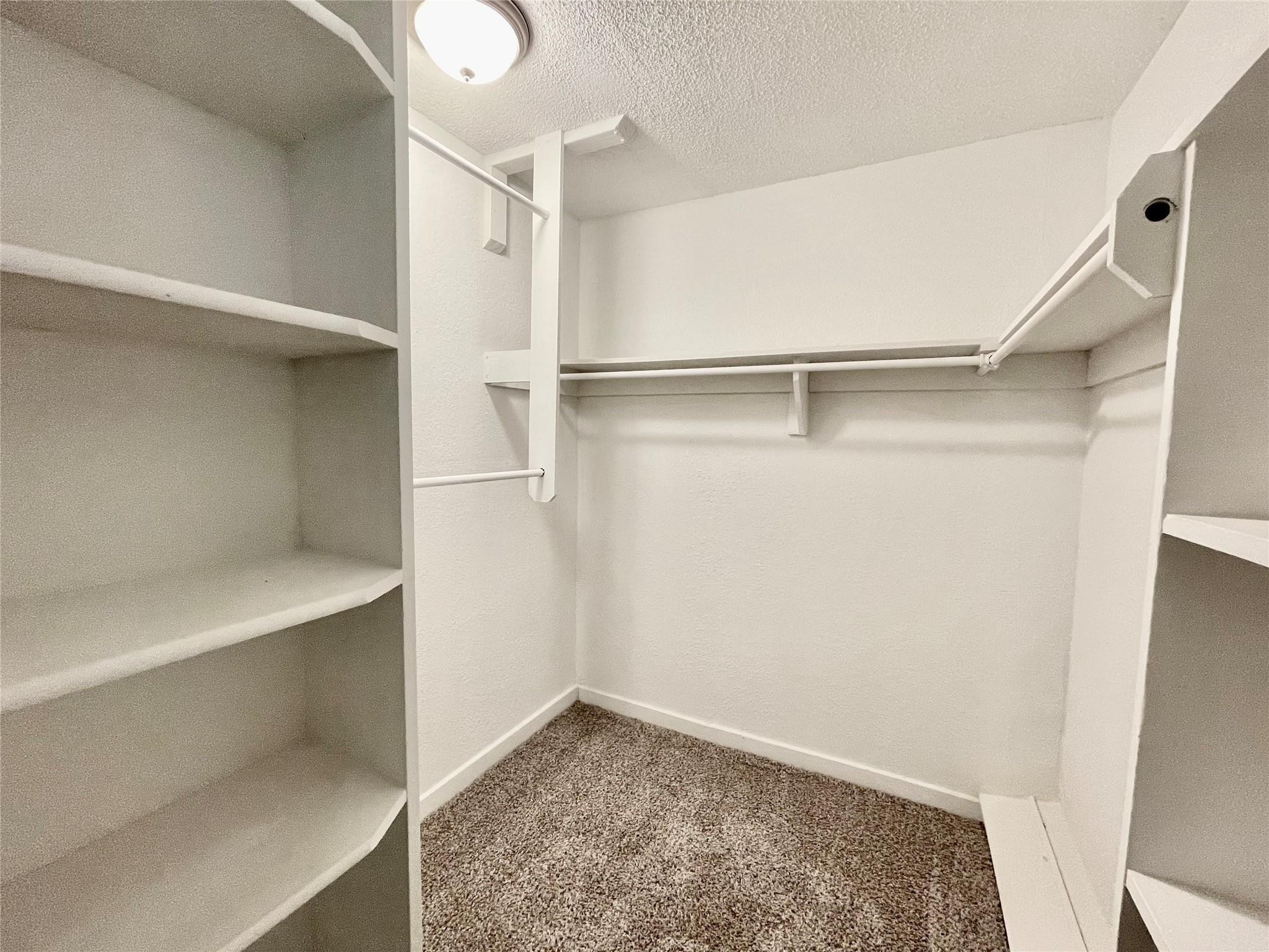 1827 Neuman La Marque, TX 77568 - Photo 18 of 23 a view of walk in closet with empty racks