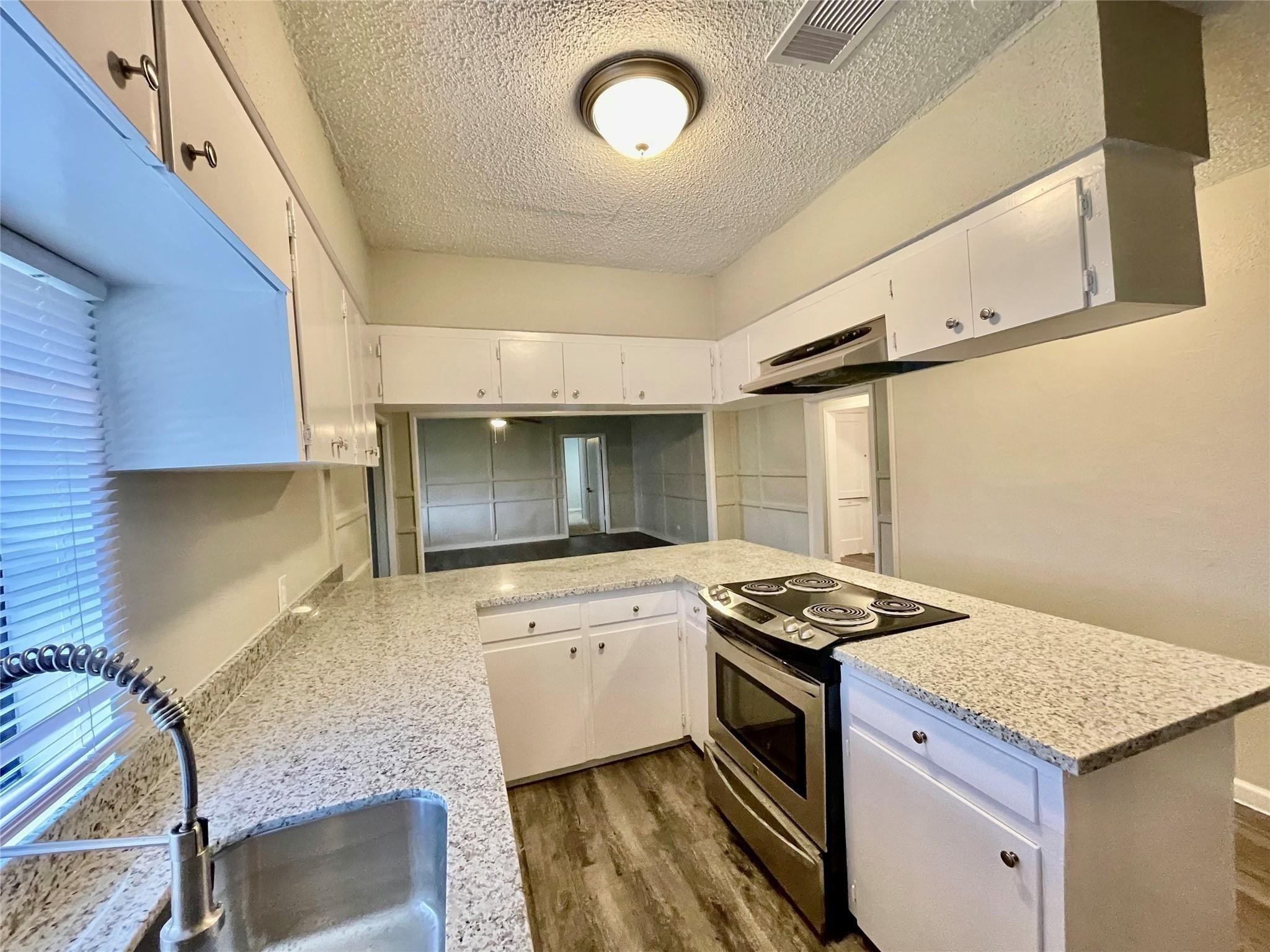 1827 Neuman La Marque, TX 77568 - Photo 10 of 23 a kitchen with granite countertop sink stove and cabinets