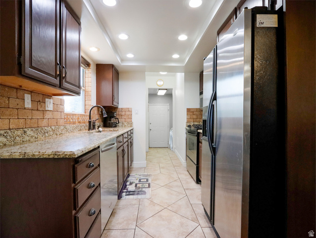 270 East 100 North Monroe, UT 84754 - Photo 15 of 65 Kitchen featuring recessed lighting, dark wood cabinetry, light-toned countertops, a brick-style backsplash, and stainless steel appliances