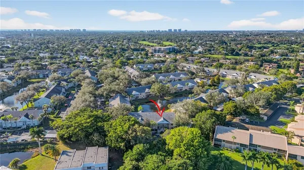 an aerial view of residential house with outdoor space and trees all around