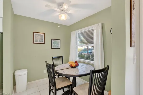 a view of a dining room with furniture and a window
