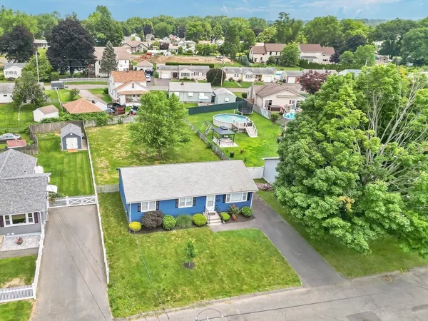 an aerial view of multiple houses with yard