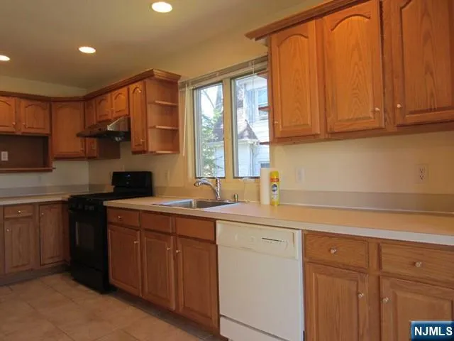 a kitchen with a sink cabinets and window