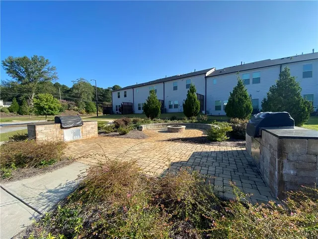 a view of a patio with furniture and plants