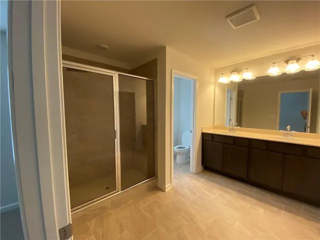 a bathroom with a double vanity sink and a mirror