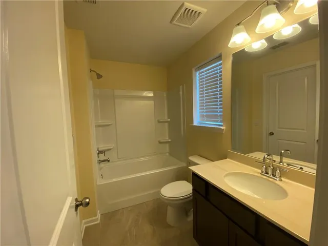 a bathroom with a sink toilet tub and shower
