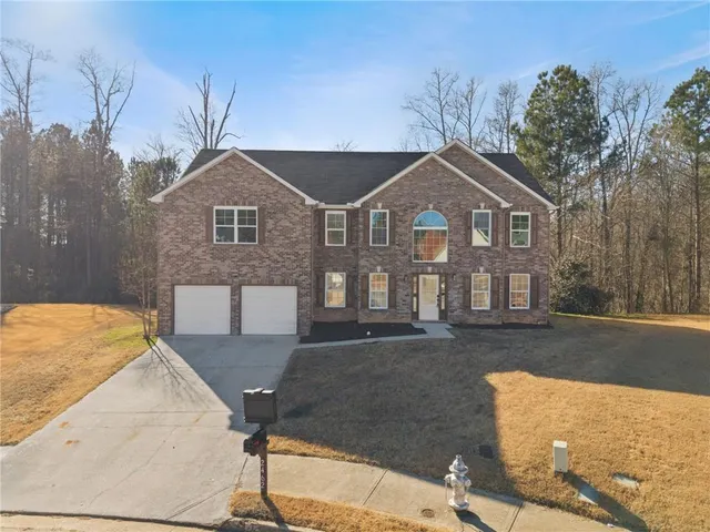 a front view of a house with a yard