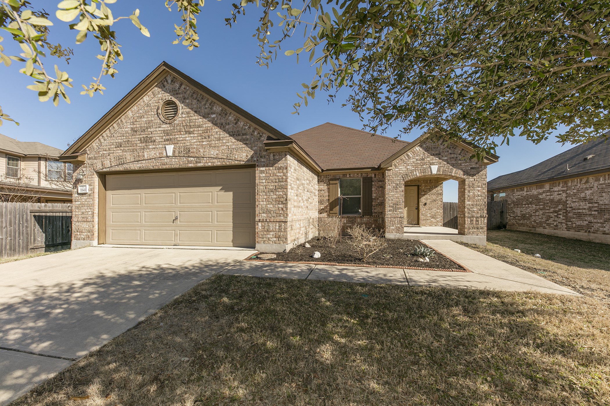 1141 Renaissance Trail Round Rock, TX 78665 - Photo 1 of 23 A well-kept brick residence awaits, featuring an inviting covered entry and attached garage.