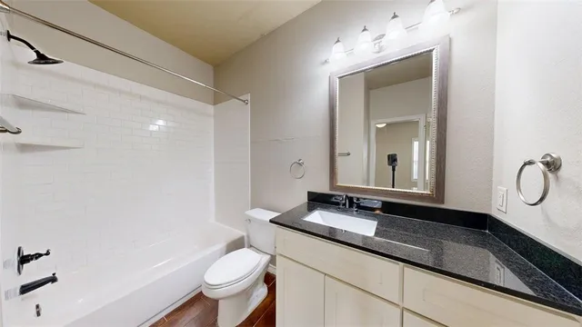 a view of a livingroom with a ceiling fan and window