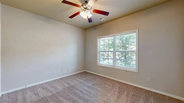 a bathroom with a granite countertop sink a toilet a mirror and shower