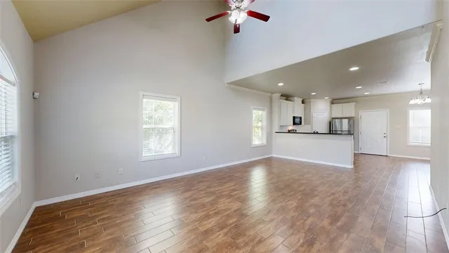 a view of kitchen and hall with wooden floor