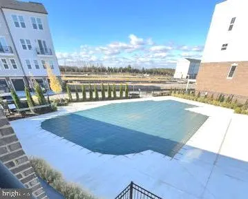 a view of a swimming pool with an ocean from a nearby room