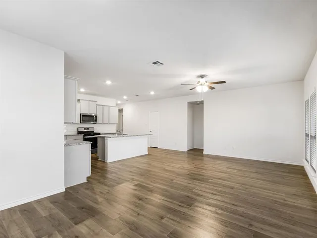 a view of kitchen with sink microwave and stove
