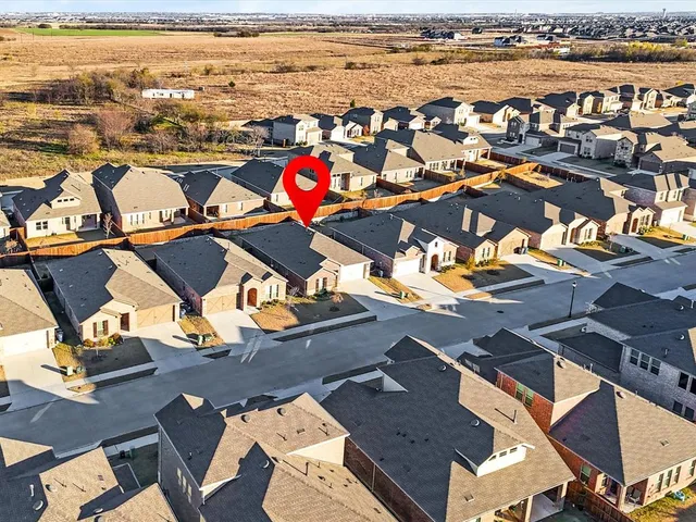 an aerial view of residential houses with outdoor space