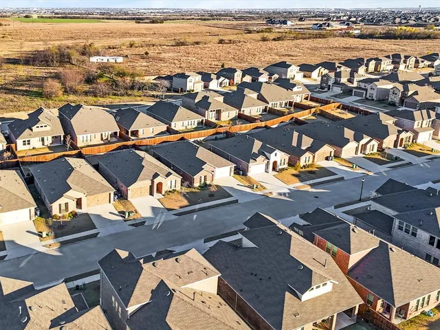 an aerial view of residential houses with outdoor space