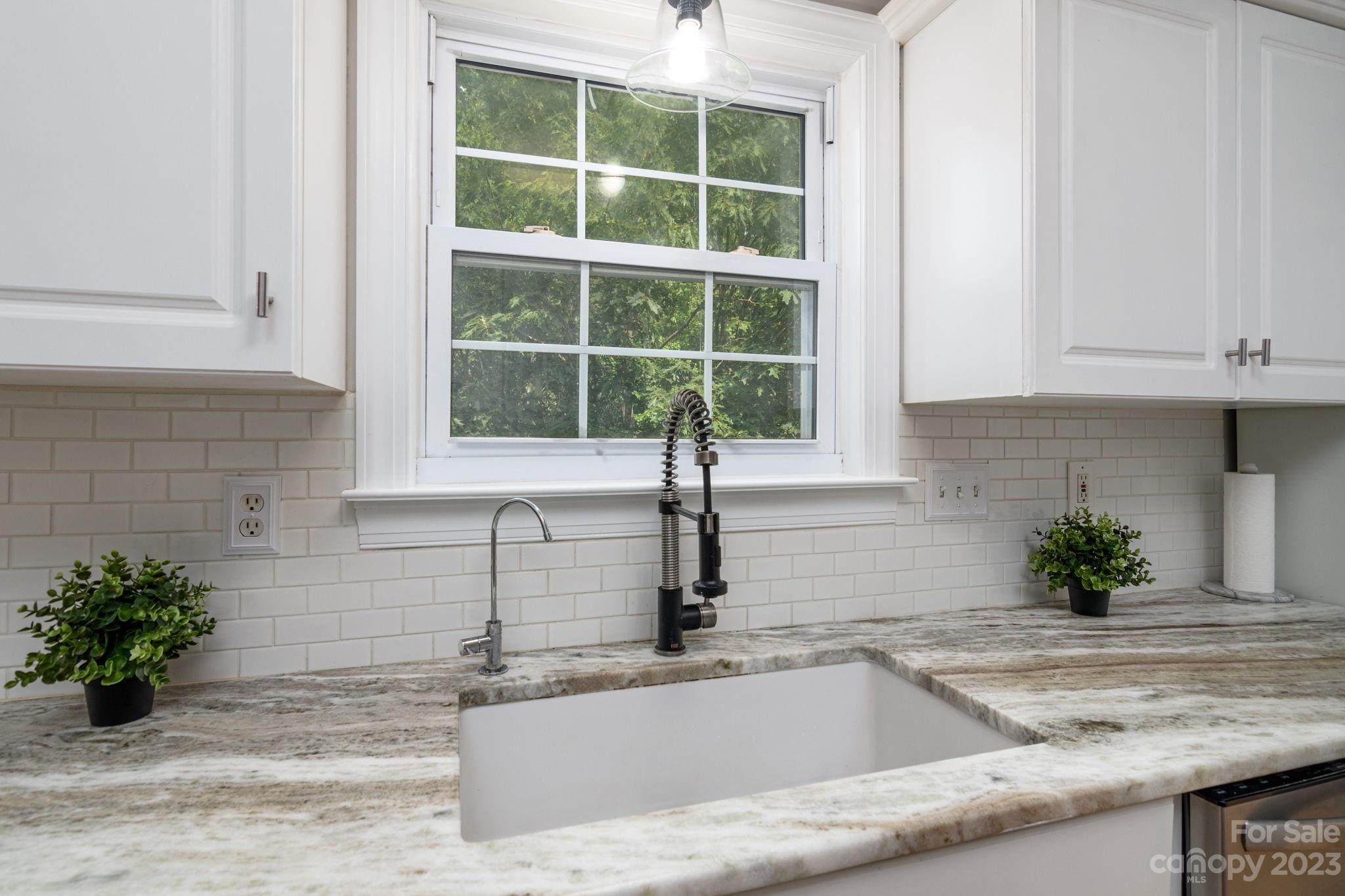 12129 Woodholm Court Tega Cay, SC 29708 - Photo 12 of 27 a kitchen with granite countertop a sink and a window