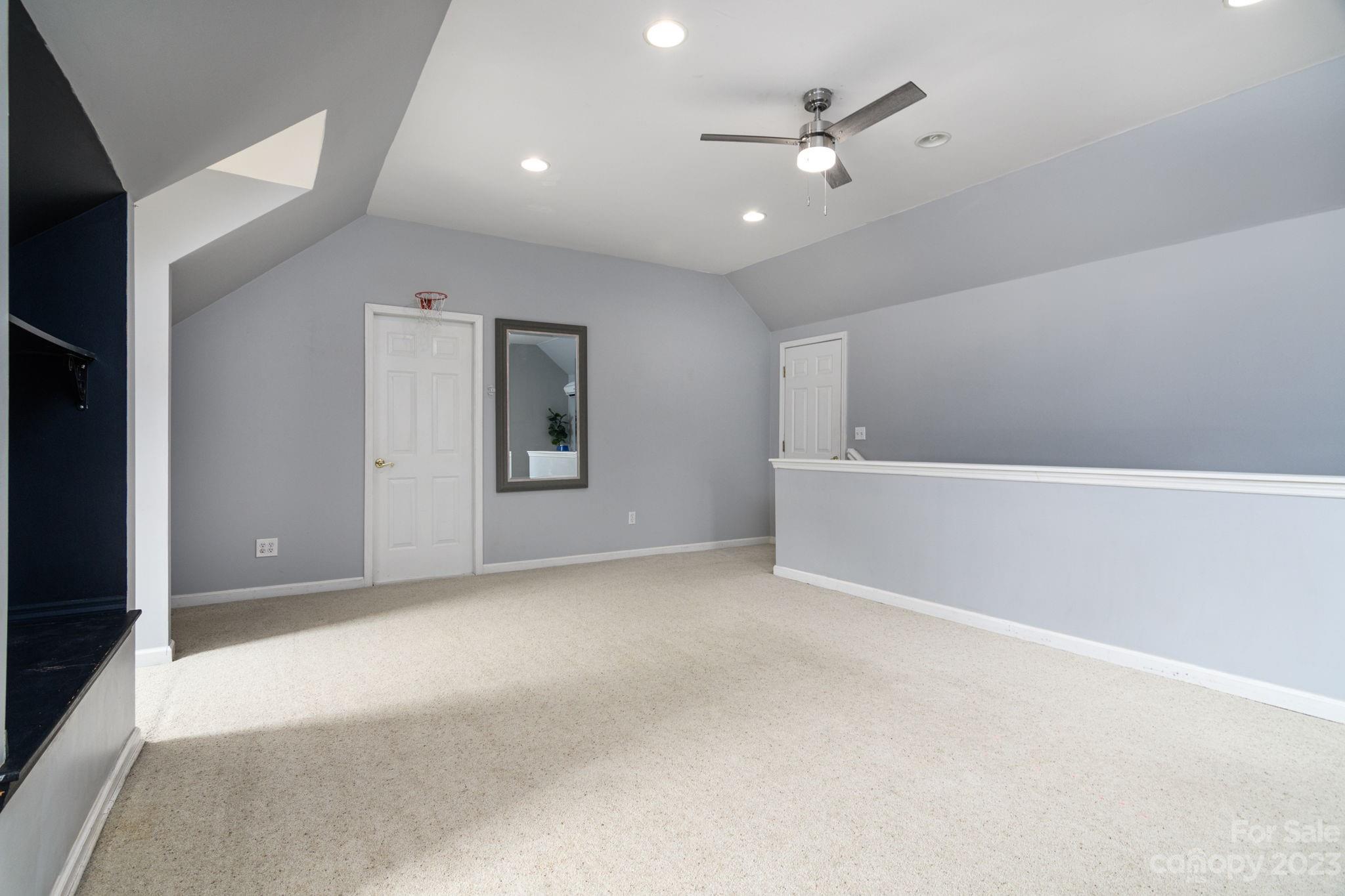 12129 Woodholm Court Tega Cay, SC 29708 - Photo 14 of 27 wooden floor in an empty room with a ceiling fan