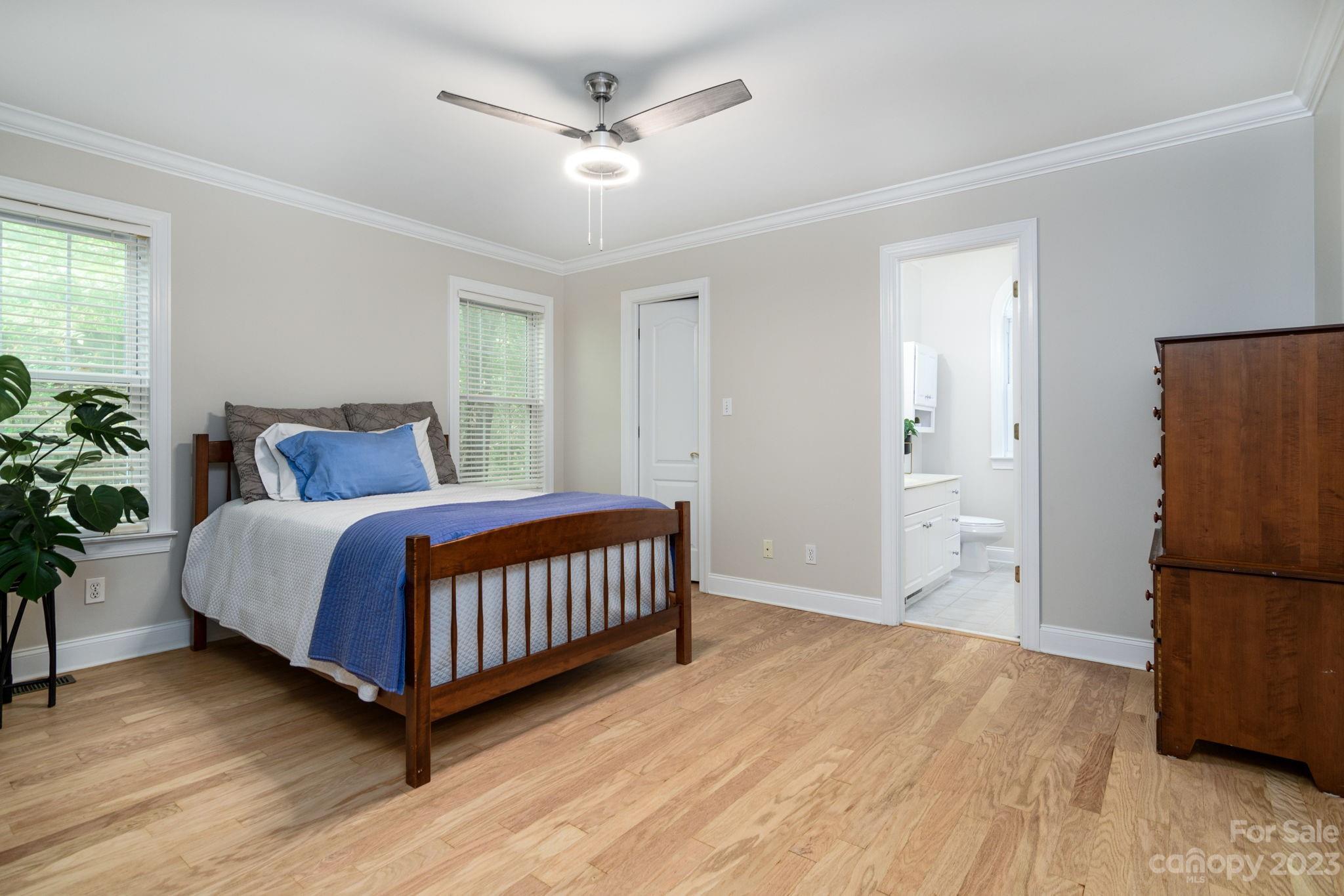 12129 Woodholm Court Tega Cay, SC 29708 - Photo 17 of 27 a bedroom with a bed and a potted plant