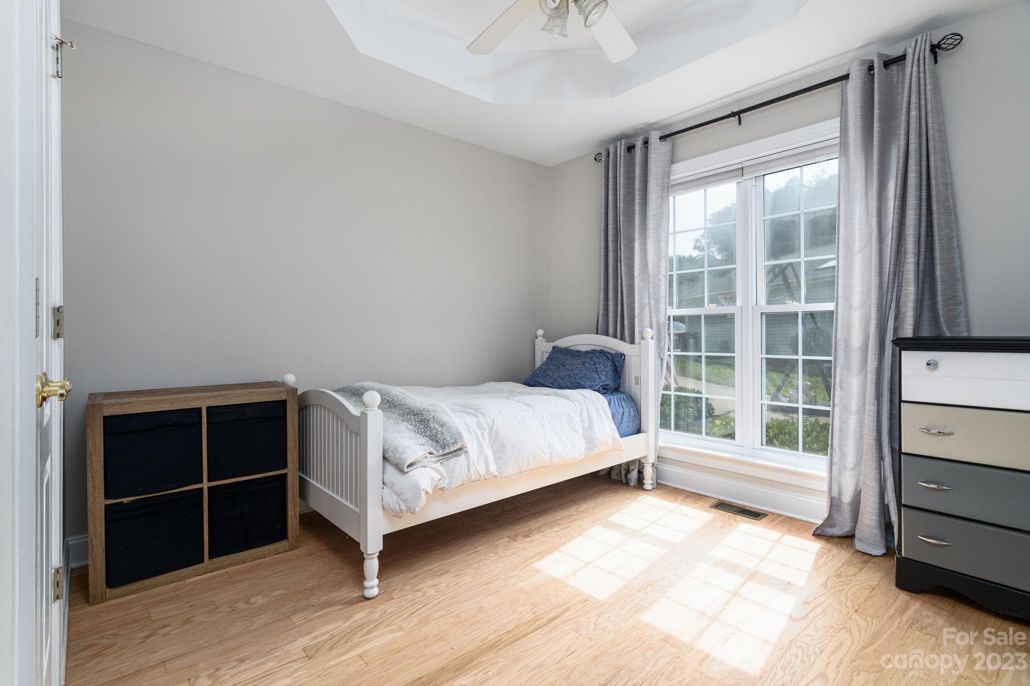 12129 Woodholm Court Tega Cay, SC 29708 - Photo 19 of 27 a bedroom with a bed and a window