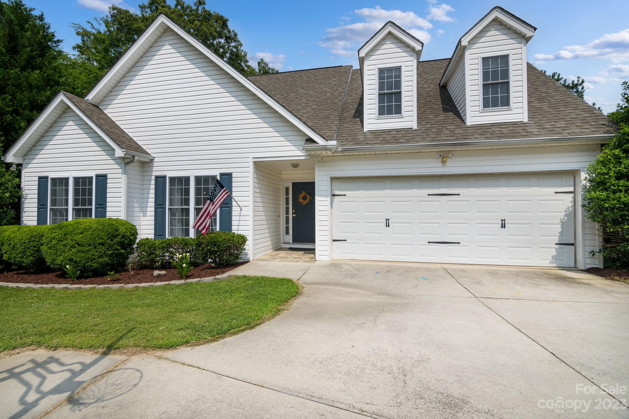 12129 Woodholm Court Tega Cay, SC 29708 - Photo 2 of 27 a front view of a house with a yard and garage