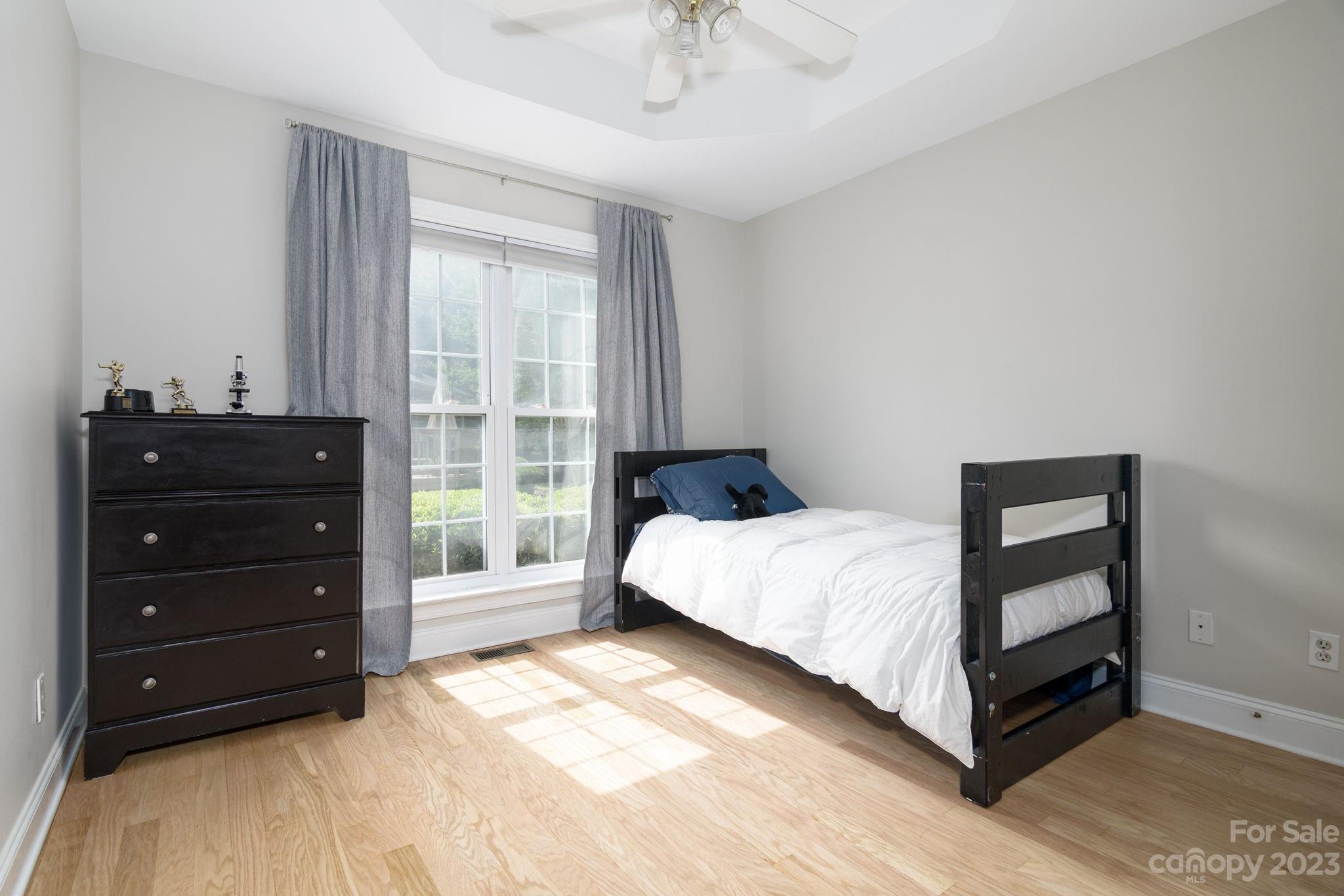 12129 Woodholm Court Tega Cay, SC 29708 - Photo 21 of 27 a bedroom with a bed and a window