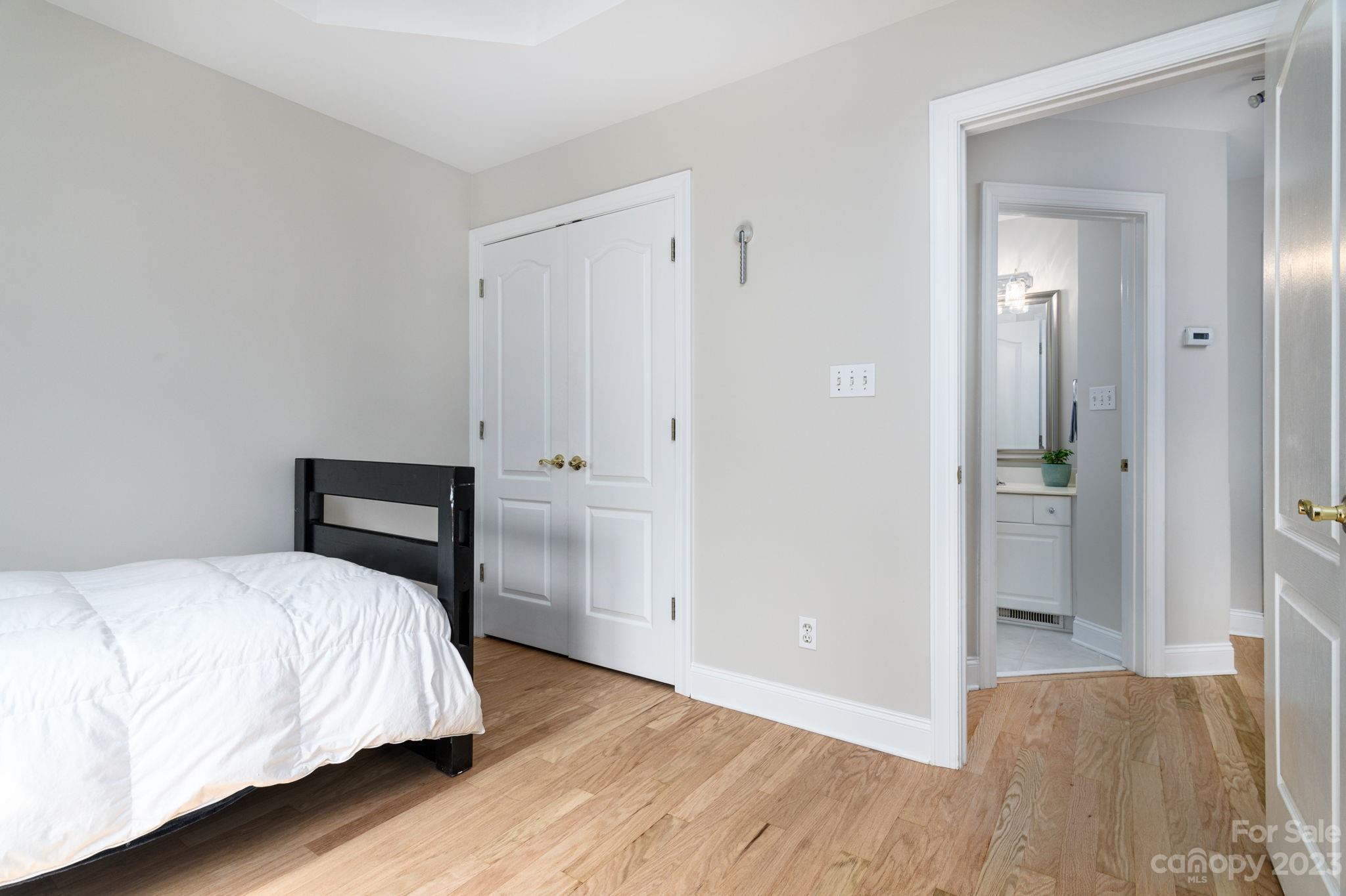 12129 Woodholm Court Tega Cay, SC 29708 - Photo 22 of 27 a bedroom with a bed and wooden floor