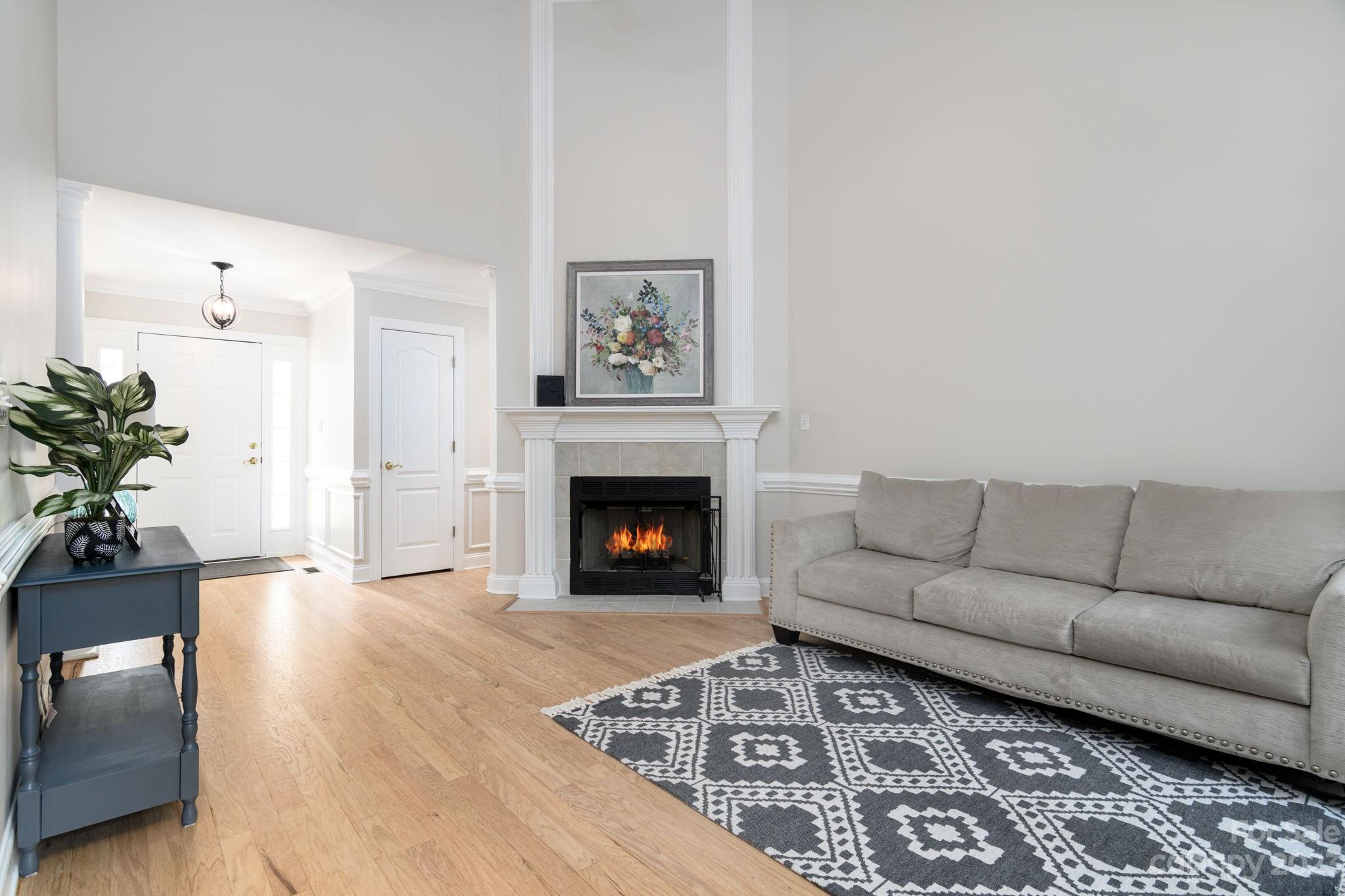 12129 Woodholm Court Tega Cay, SC 29708 - Photo 7 of 27 a living room with furniture and a fireplace