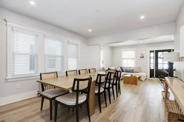 a view of a a dining room with furniture window and wooden floor
