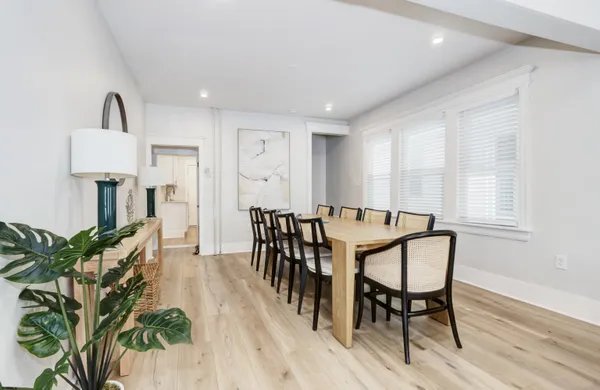 a view of a a dining room with furniture window and wooden floor