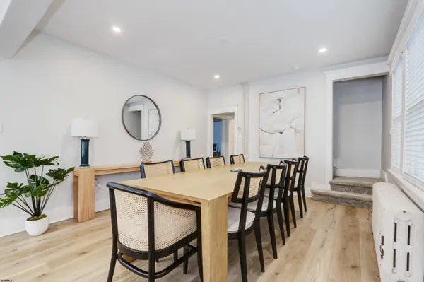a view of a a dining room with furniture window and wooden floor