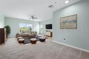 a living room with couches and a flat screen tv
