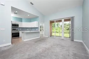 a view of a kitchen with a sink and a large window