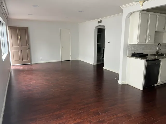 a kitchen with kitchen island a sink appliances and cabinets