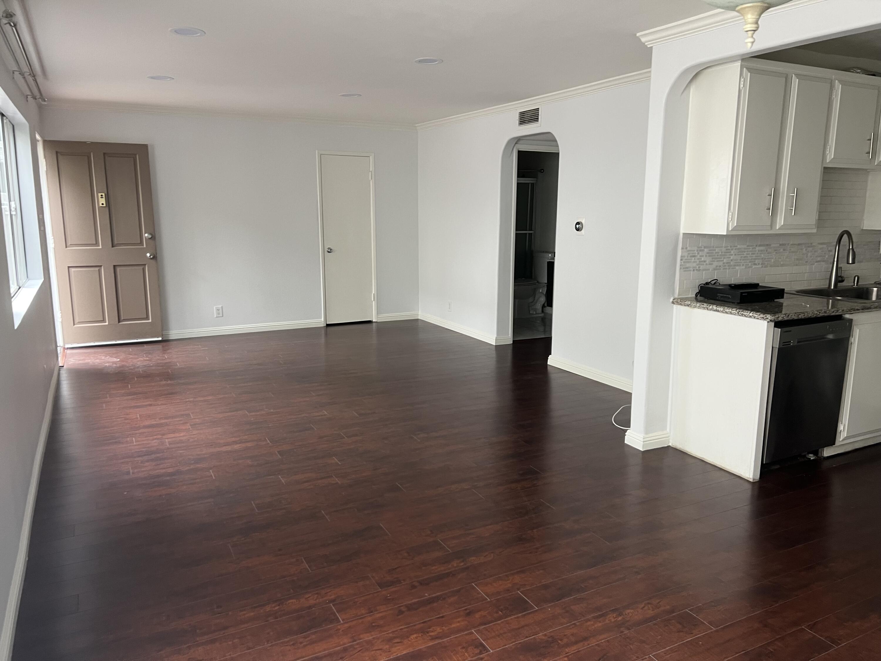 18555 Collins Street, Unit C8 Tarzana, CA 91356 - Photo 13 of 32 a view of a kitchen with wooden floor and a refrigerator