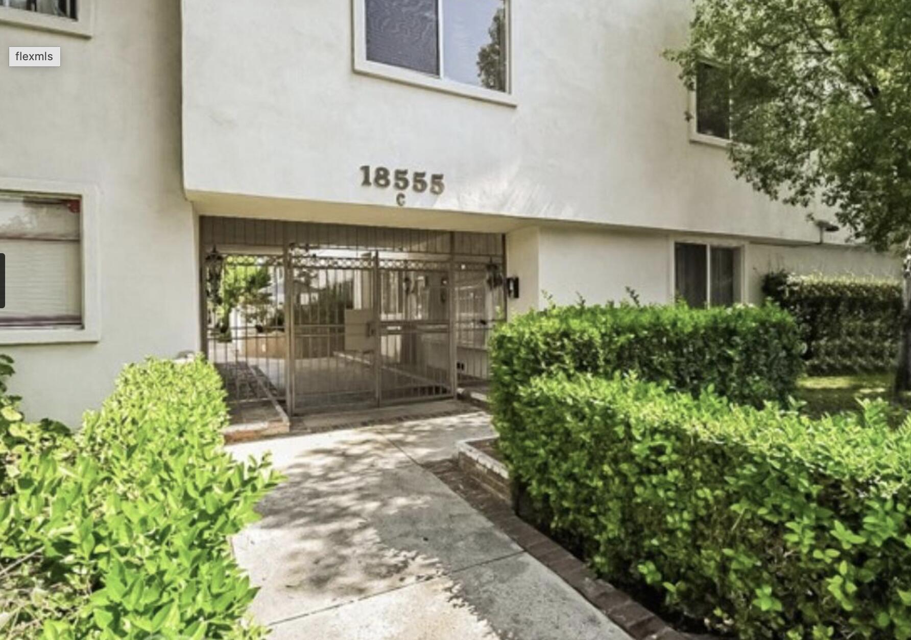 18555 Collins Street, Unit C8 Tarzana, CA 91356 - Photo 20 of 32 a flower garden is sitting in front of a building