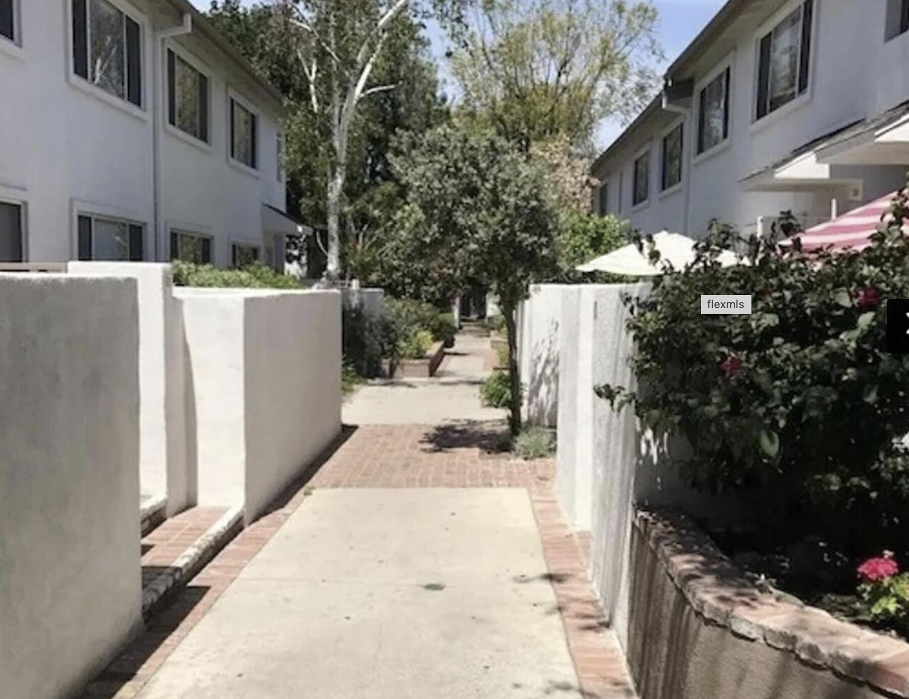 18555 Collins Street, Unit C8 Tarzana, CA 91356 - Photo 21 of 32 a view of a white building with many windows