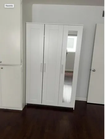 an empty room with wooden floor